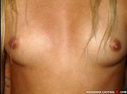 Nicky angel is sited on a sofa, legs appart and looking at you