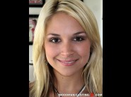 Sarah vandella is sited on a sofa, legs appart and looking at you