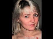 Chantal petite is sited on a sofa, legs appart and looking at you