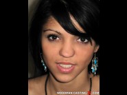 Furiya is sited on a sofa, legs appart and looking at you