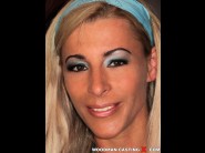 Jenna jane is sited on a sofa, legs appart and looking at you