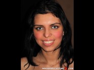 Kira queen is sited on a sofa, legs appart and looking at you