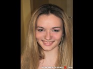 Bambina is sited on a sofa, legs appart and looking at you