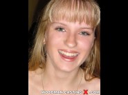 Yanna is sited on a sofa, legs appart and looking at you