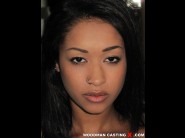 Skin diamond is sited on a sofa, legs appart and looking at you