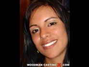 Simony lovely is sited on a sofa, legs appart and looking at you