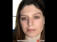 Amelie is sited on a sofa, legs appart and looking at you