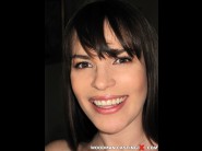 Dana de armond is sited on a sofa, legs appart and looking at you