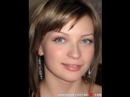 Oxana blue is sited on a sofa, legs appart and looking at you