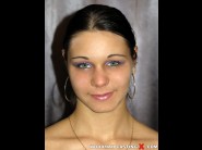 Suzy white is sited on a sofa, legs appart and looking at you