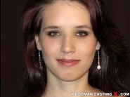 Shylina is sited on a sofa, legs appart and looking at you