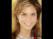 Nella is sited on a sofa, legs appart and looking at you