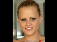 Monica sweet is sited on a sofa, legs appart and looking at you