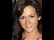 Tess is sited on a sofa, legs appart and looking at you