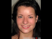 Mella is sited on a sofa, legs appart and looking at you