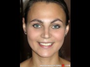 Sarah feline is sited on a sofa, legs appart and looking at you