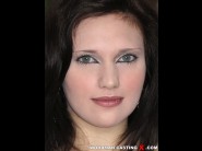 Lulu pretel is sited on a sofa, legs appart and looking at you