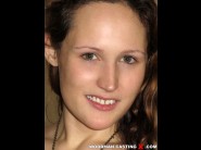 Emy russo is sited on a sofa, legs appart and looking at you