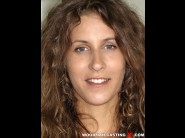 Kate beaudy is sited on a sofa, legs appart and looking at you