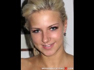 Nataly cherie is sited on a sofa, legs appart and looking at you