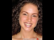 Melinda is sited on a sofa, legs appart and looking at you