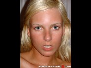 Alexandra bordas is sited on a sofa, legs appart and looking at you