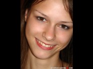 Beata undine is sited on a sofa, legs appart and looking at you