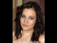 Fawny is sited on a sofa, legs appart and looking at you