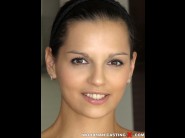 Eve angel is sited on a sofa, legs appart and looking at you