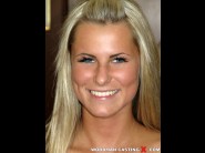 Sandra hill is sited on a sofa, legs appart and looking at you