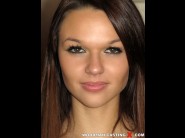 Frida is sited on a sofa, legs appart and looking at you