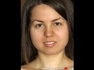 Jalace is sited on a sofa, legs appart and looking at you