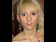 Margot lancer is sited on a sofa, legs appart and looking at you