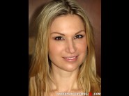 Carol goldnerova is sited on a sofa, legs appart and looking at you