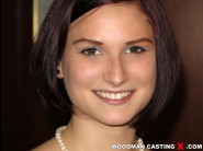 Narcissa is sited on a sofa, legs appart and looking at you