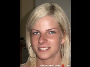 Nikky is sited on a sofa, legs appart and looking at you