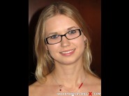 Violette pure is sited on a sofa, legs appart and looking at you