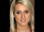 Alannis is sited on a sofa, legs appart and looking at you