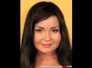 Ilona fox is sited on a sofa, legs appart and looking at you