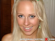 Carla cox is sited on a sofa, legs appart and looking at you