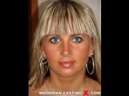 Michaella is sited on a sofa, legs appart and looking at you