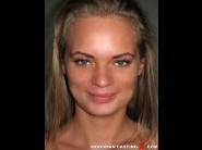 Martina rotts is sited on a sofa, legs appart and looking at you