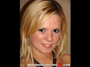 Yasmine gold is sited on a sofa, legs appart and looking at you