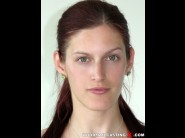 Mira sunset is sited on a sofa, legs appart and looking at you