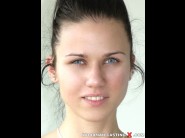 Denise sky is sited on a sofa, legs appart and looking at you