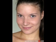 Anita bellini is sited on a sofa, legs appart and looking at you