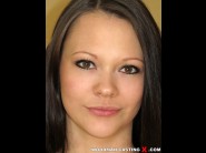 Laura brook is sited on a sofa, legs appart and looking at you