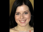 Daniella rose is sited on a sofa, legs appart and looking at you