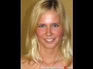 Tracy gold is sited on a sofa, legs appart and looking at you