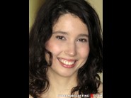 Kyrashina is sited on a sofa, legs appart and looking at you